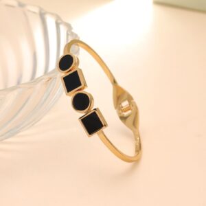 Geometric Black Enamel Hinged Bangle – Gold Tone