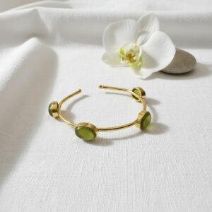 Gold open cuff bangle with olive green cabochon stones