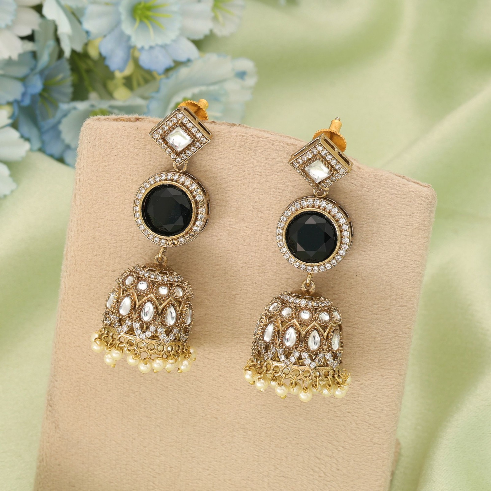 Antique gold statement jhumka earrings featuring square diamond-shaped Kundan studs, circular jet black Monalisa stones, and pearl-edged dome drops.