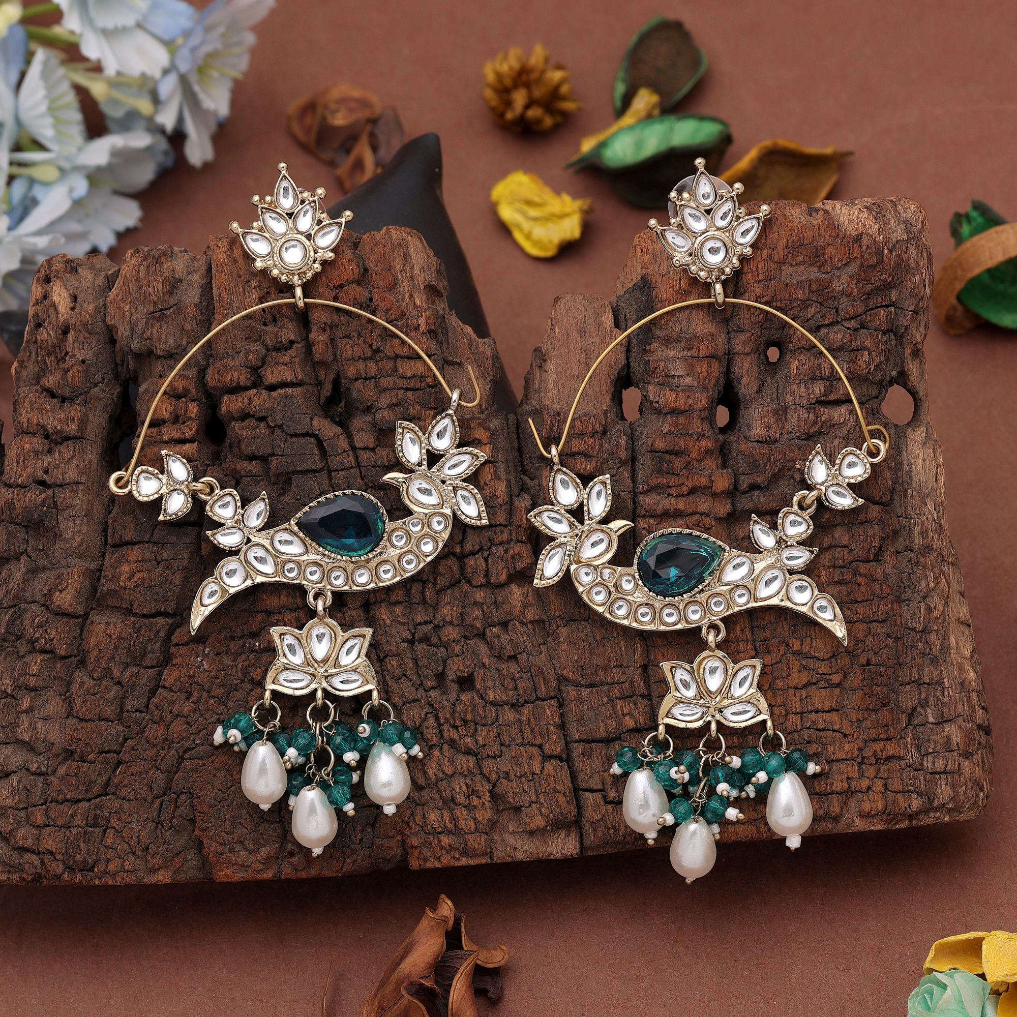 A pair of oversized antique gold-plated hoop chandbali earrings adorned with multi-shaped Kundan stones, a large central faceted gemstone, and a dangling fringe of tiny black micro-beads paired with smooth white pearl droplets.