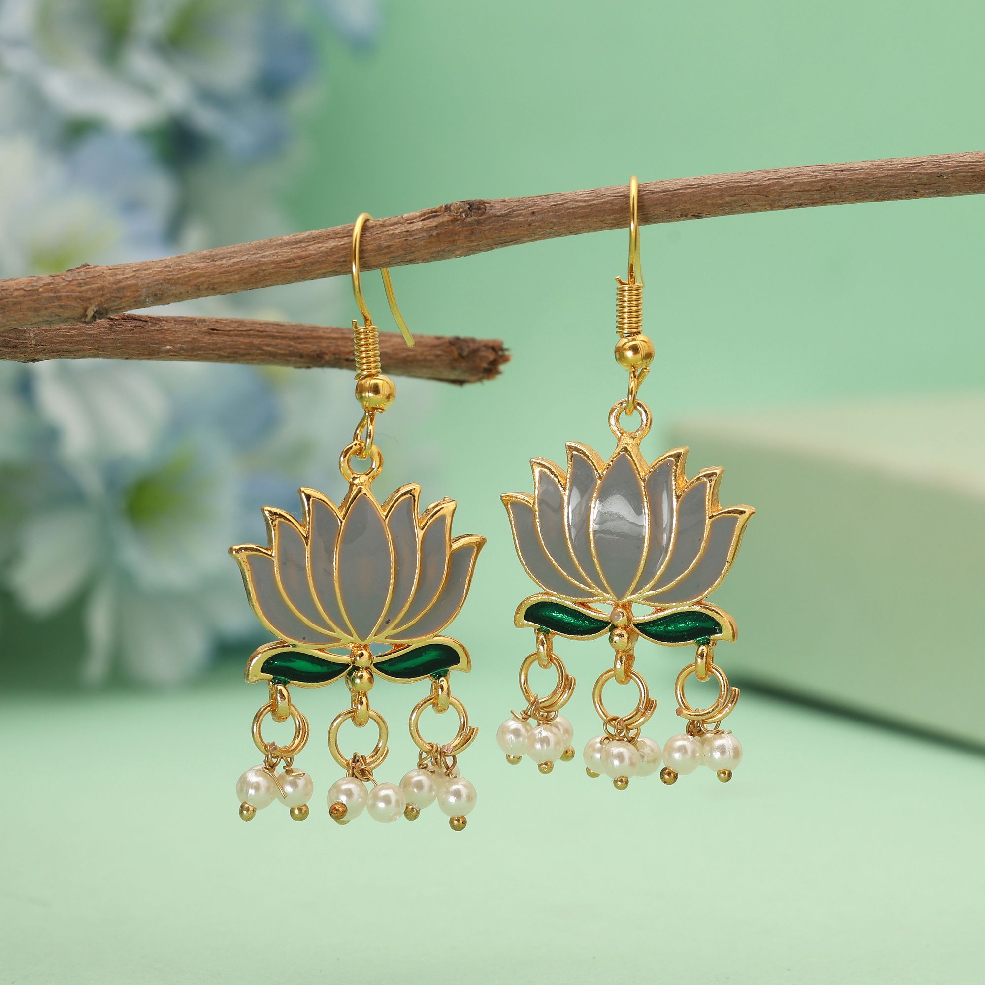 Handpainted lotus Meenakari dangle earrings with pearl drops on a gold-coloured fishhook.