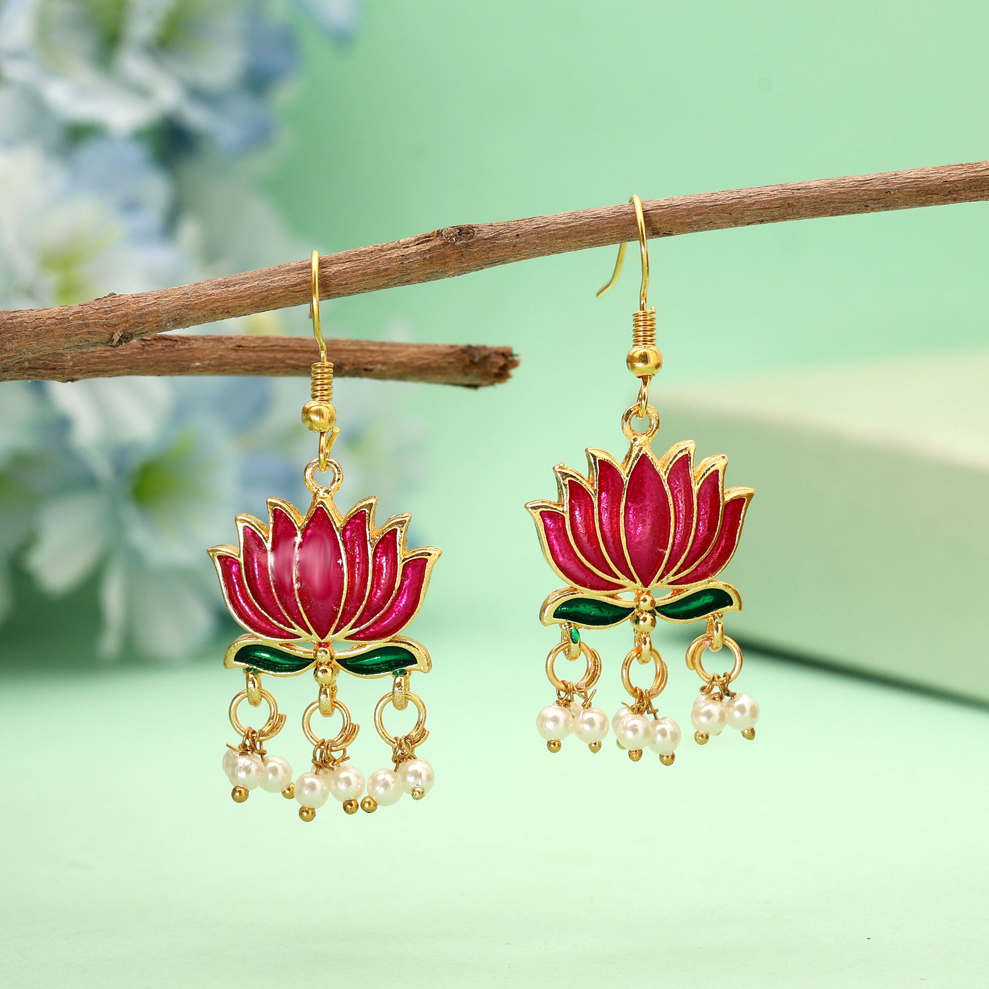 Handpainted lotus Meenakari dangle earrings with pearl drops on a gold-coloured fishhook.