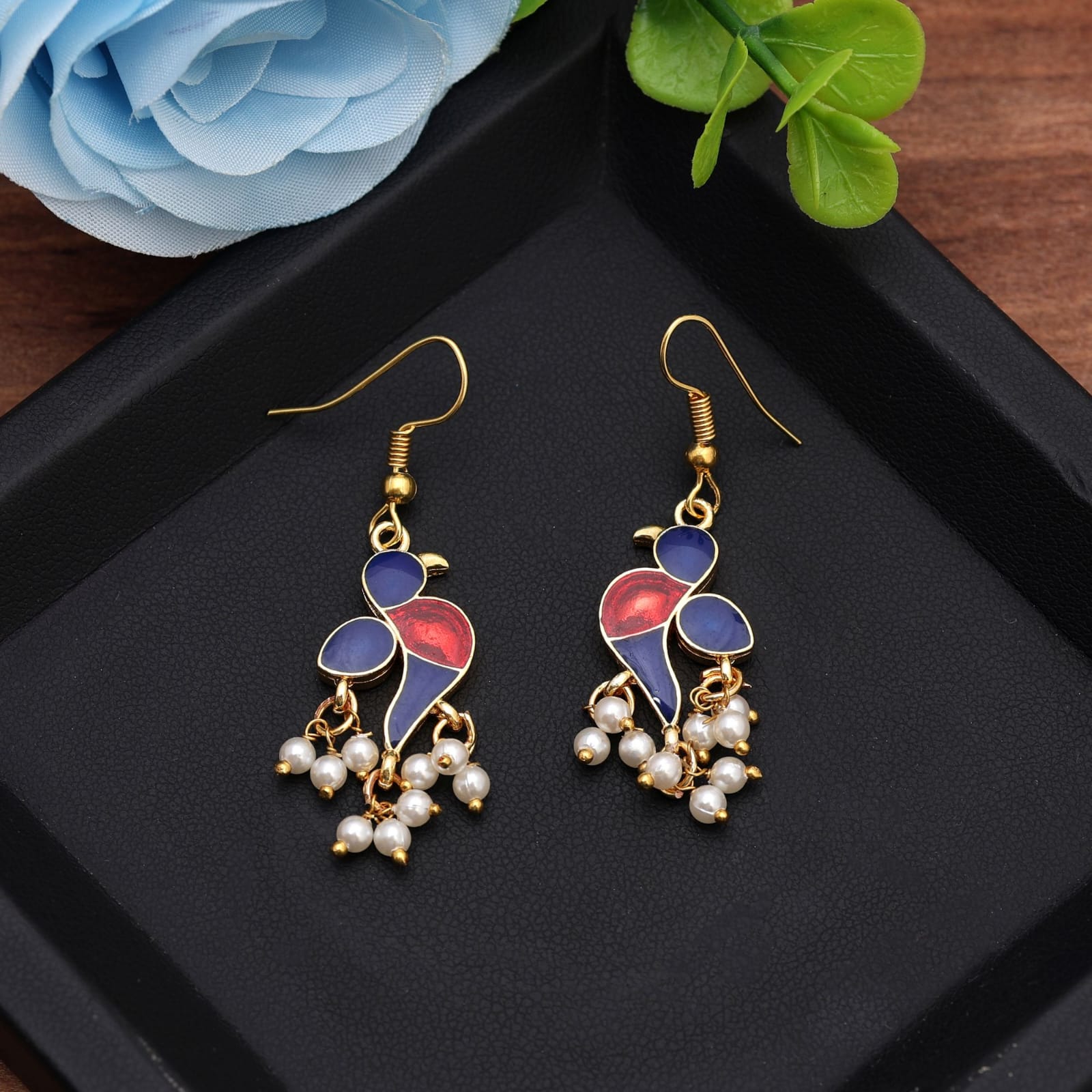 fish-hook drop earrings featuring navy blue and glossy red enamel bird design with dangling white pearl clusters.