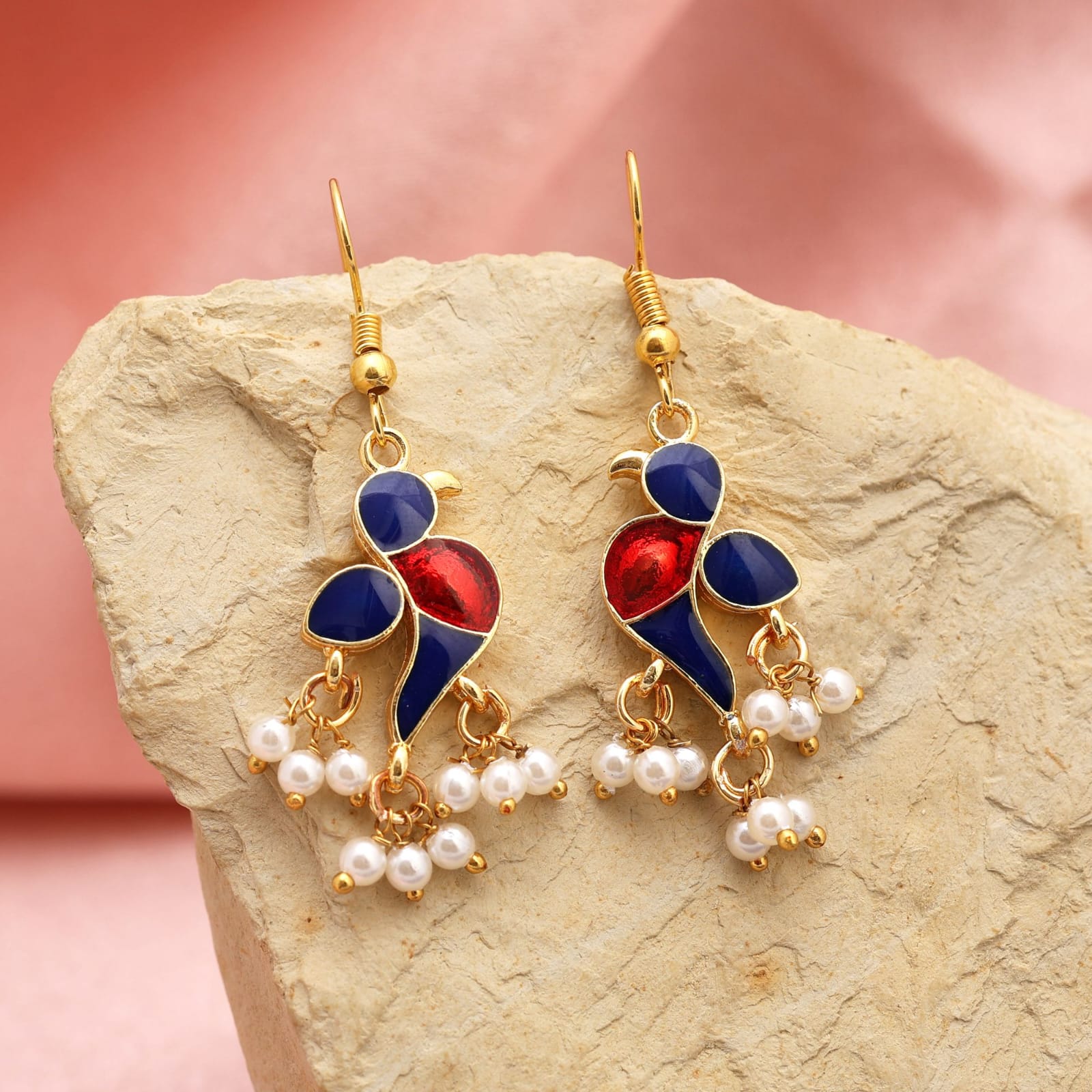 fish-hook drop earrings featuring navy blue and glossy red enamel bird design with dangling white pearl clusters.